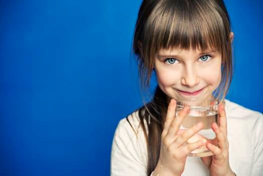 Young girl with glass of water